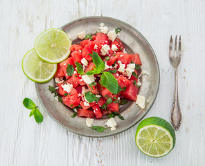 Fresh salad with water-melon, feta cheese, lime and mint.