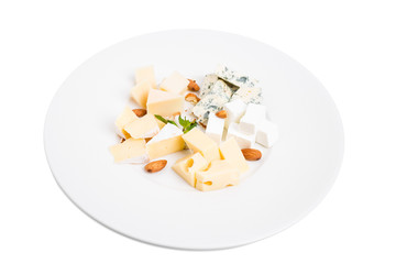 Assorted cheese platter with almonds and mint.