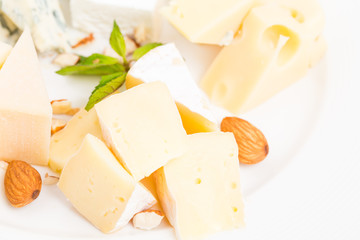 Assorted cheese platter with almonds closeup.