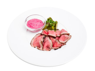 Sliced roast beef with pickles.