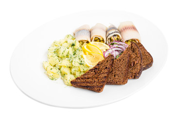 Salted herring fillet with pickles and potatoes.