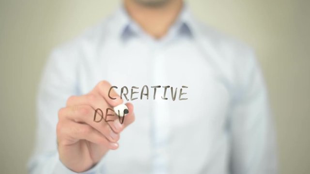 Creative Development,  Man writing on transparent screen