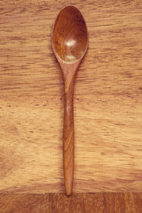 wood spoon on wood background dark brown.