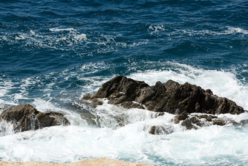 Fototapeta premium Wave splashing over a rock on Caleta Negra beach in Ajuy on Fuerteventura. Canary Island, Spain