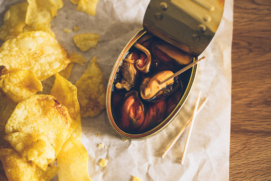 Delicious appetizer of a can of mussels and fries