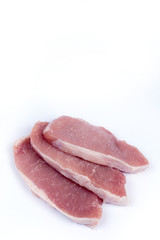 Three pork chops isolated over white background