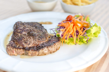 beef steak and vegetables with tomatoes and french fried