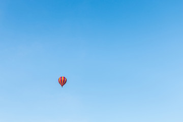 colorful hot air balloon in blue cloudy sky