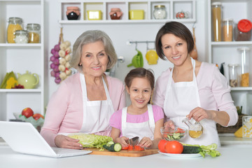 women with little girl cooking