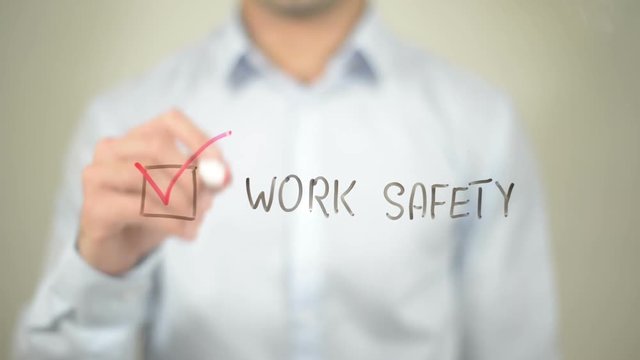 Work Safety,  Man writing on transparent screen
