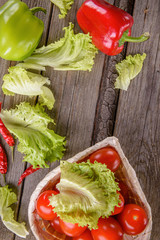 Vegetables on wooden boards. pepper, tomatoes, lettuce.