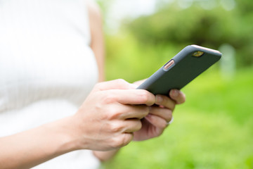 Woman sending text message on cellphone