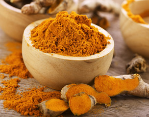 Turmeric roots in the basket on wooden