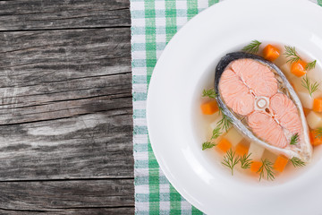 salmon soup with vegetables and dil, top view