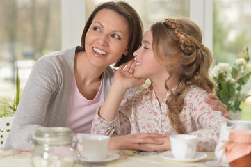 little girl telling a secret 