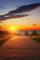 path near the sea at sunset