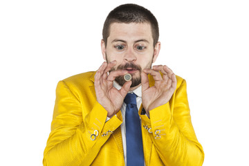 businessman with big eyes looking at his coin