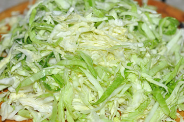 Cabbage chopped slice heap on wooden board