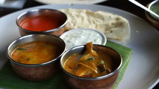 Indian curries different color and nan bread serve in restaurant