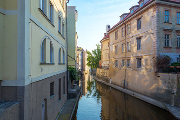 view of the narrow channel among houses in Prague