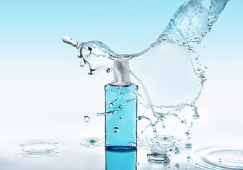 Blue moisturizing shampoo stays on the blue water background with big splash above the bottle and...