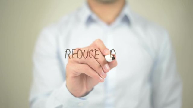 Reduce Risk,  Man writing on transparent screen