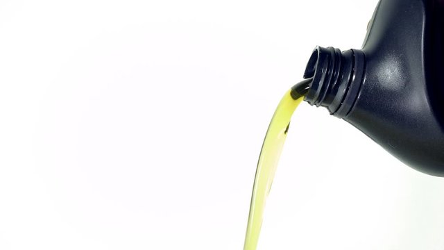 Can with car engine oil pouring in front white background
