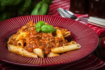 Penne a bolognese on white plate.