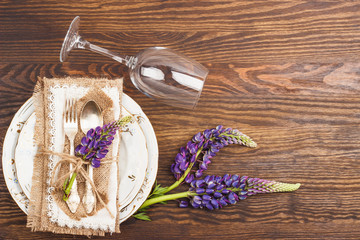 Obraz na płótnie Canvas Tableware with violet lupinus and silverware