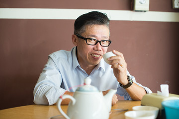 asian senior male enjoying tea