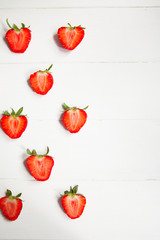 Strawberries on white wooden background with copyspace. Healthy food concept. Fresh summer background.
