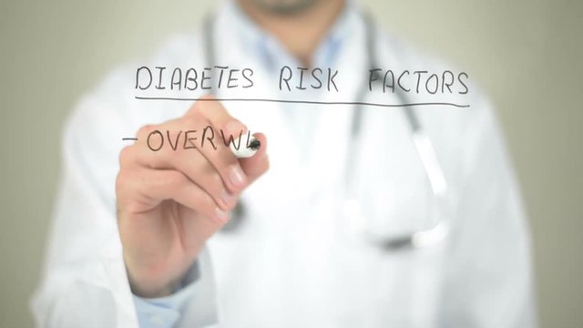 Diabetes Risk Factors, Doctor writing on transparent screen