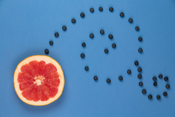 Citrus fruit with blueberry twigs monogram on a blue background
