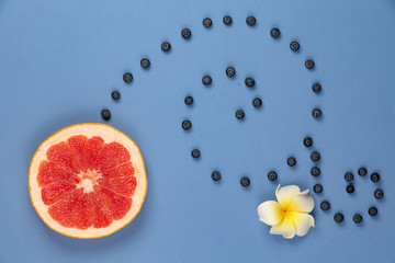 Citrus fruit with blueberry twigs monogram on a blue background and white flower