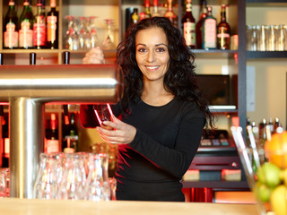 Woman bartender with a glass of beer at work - obrazy, fototapety, plakaty