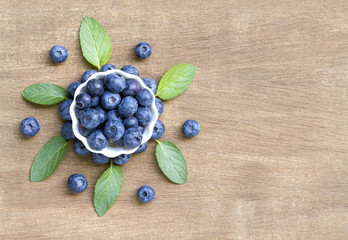 Fresh blueberries with mint leaves. Top view