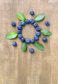 Fresh blueberries with mint leaves. Top view