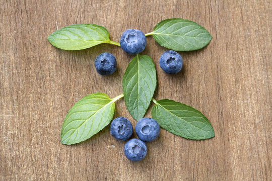 Fresh blueberries with mint leaves. Top view