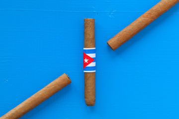 Detail of luxury Cuban cigars on the blue table