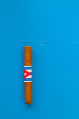 Detail of luxury Cuban cigars on the blue table