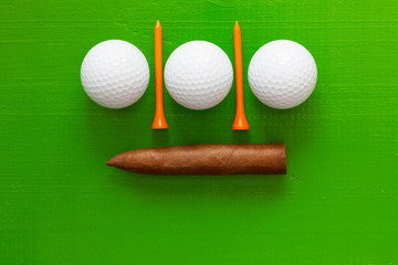 Luxury Cuban cigar and golf equipments on the  green table