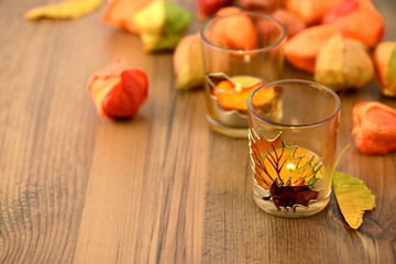 autumn tealight decoration on table with chinse lantern seeds