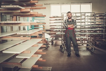 Carpenter doing his job in carpentry workshop.