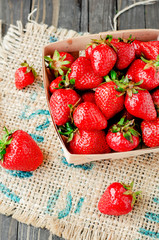 
berries, fresh ripe juicy summer useful red strawberries in a wooden basket on a wooden dark background