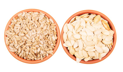 Two bowls  sunflower seeds and pumpkin isolated on white background. 