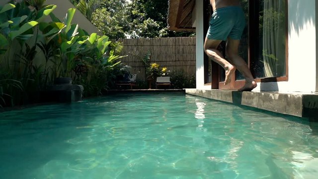 Man jumping into swimming in pool, super slow motion 240fps 

