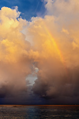 rainbow beautiful seaside at the time of sunset, storm clouds