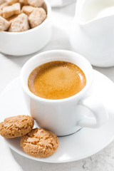 cup of espresso and almond cookies on a white table, closeup 