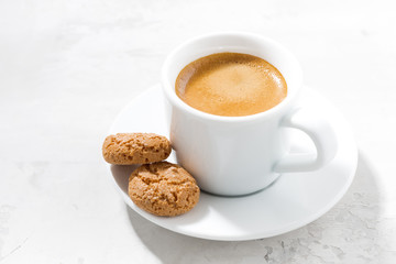cup of espresso and almond cookies on a white table
