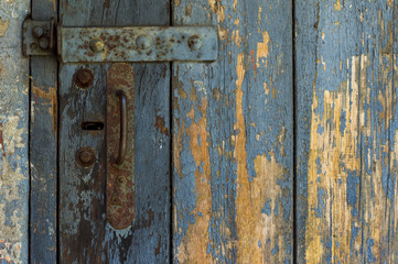 An Old Wooden Door With Cracked Paint. Background. Handle With Keyhole. The Old Iron.